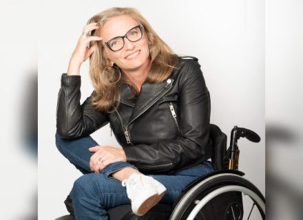 Julie Sawchuk sits in a manual wheelchair with her legs crossed.