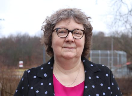 Karen McCall. A woman with short curly hair and glasses looking directly into the camera.