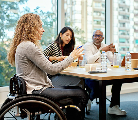 Group of co-workers meeting at a board table.